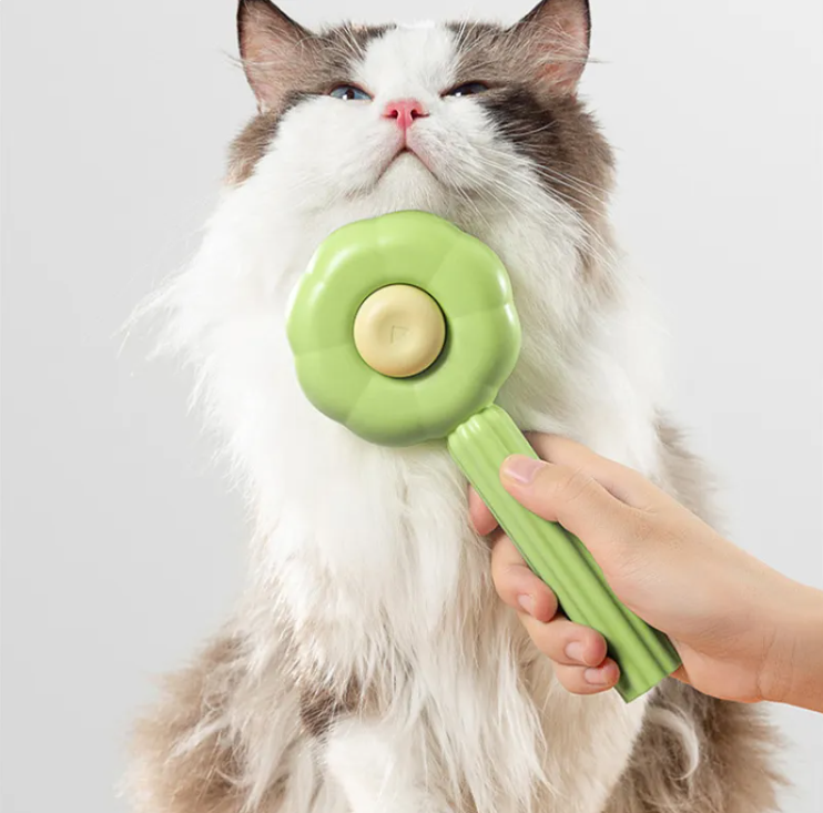 Nuzzl Self-Cleaning Deshedding Brush grooming a fluffy cat