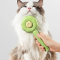 Nuzzl Self-Cleaning Deshedding Brush grooming a fluffy cat